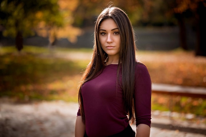 Young woman in burgundy top outdoors