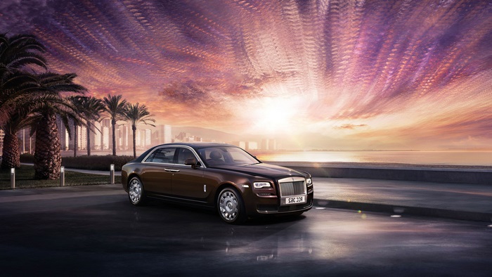 Rolls-Royce Ghost on a coastal road at sunset