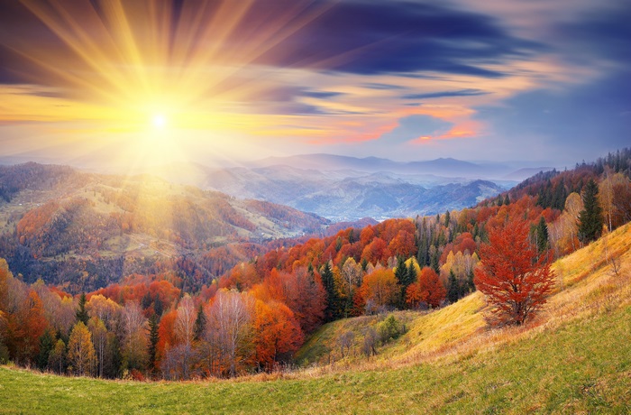 Autumn mountain landscape with sun rays