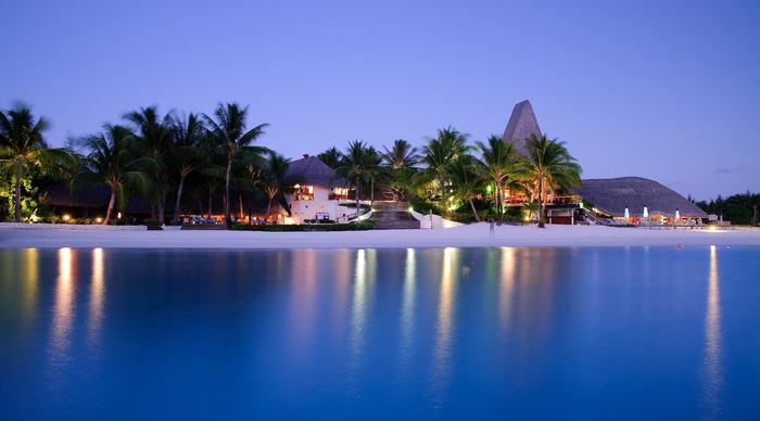Resort with palm trees on beach at dusk, Polynesia 4K
