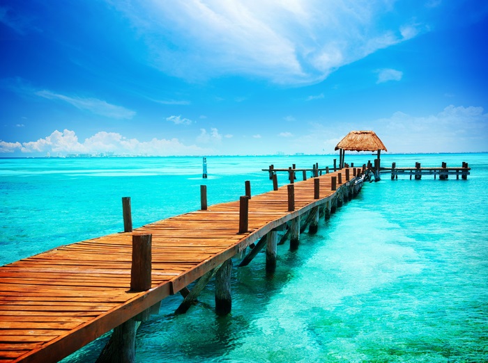 4K Vibrant Wooden Pier Over Clear Turquoise Water Mexico