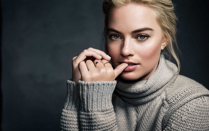 Margot Robbie in a grey turtleneck sweater
