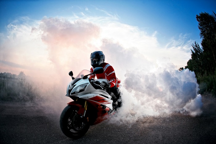 Motorcyclist performing a burnout in smoke