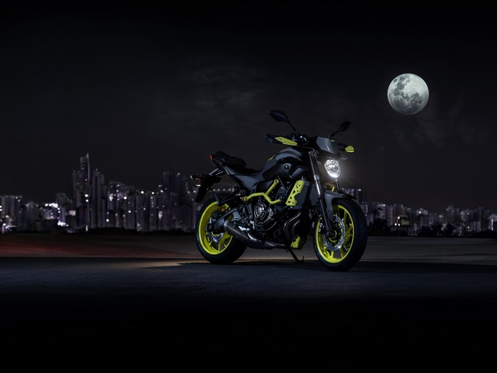 Yamaha MT-07 motorcycle at night with city skyline and moon