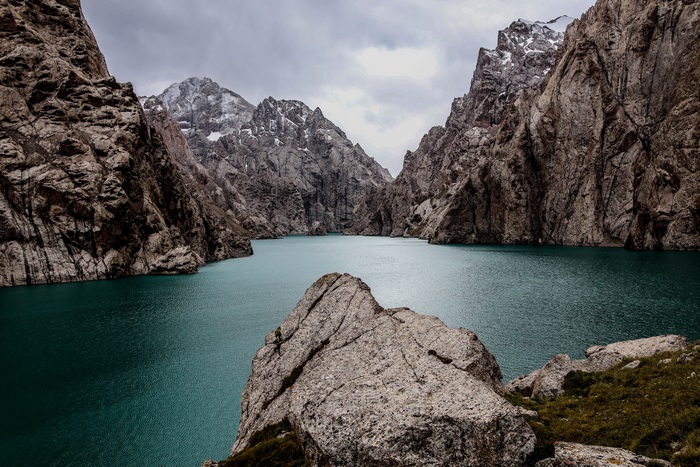 Turquoise lake surrounded by rocky mountains