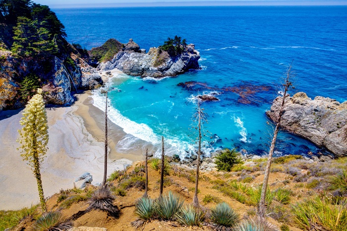 Beach with turquoise water and cliffs