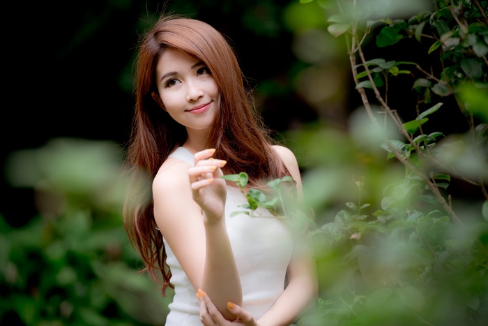 Smiling Asian Woman in Nature with 4K Clarity
