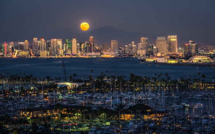 San Diego skyline and harbor at night with full moon