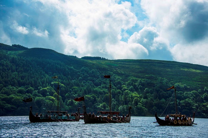 Vikings on a lake with forested hills