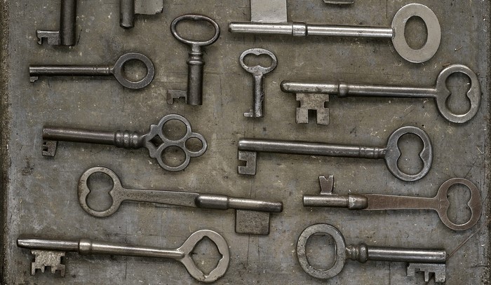 Collection of antique and vintage keys on a textured surface
