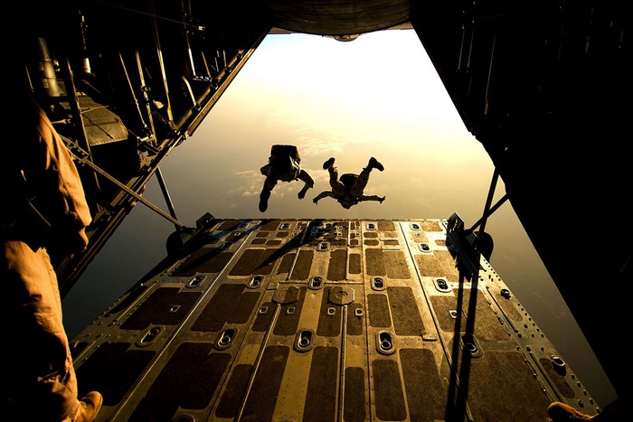 Military paratroopers jumping from an aircraft
