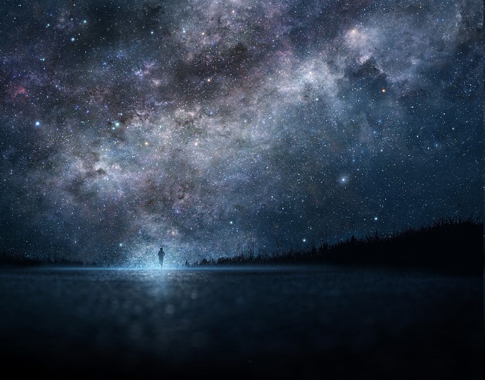 Person standing under a starry sky