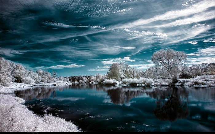 Winter lake landscape with infrared sky and trees