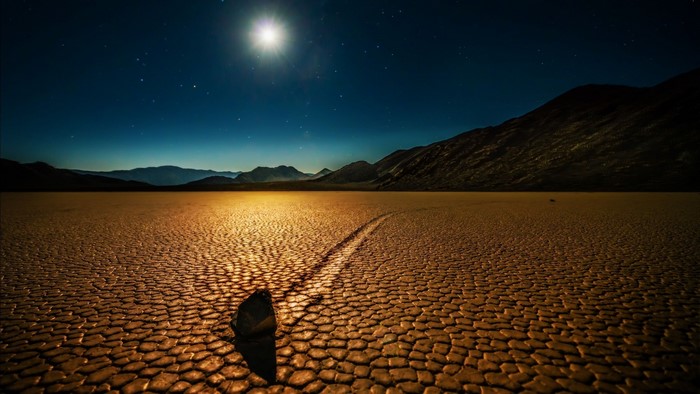 Moving rock on Death Valley Racetrack Playa at night