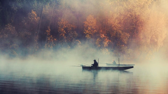 Misty Morning Fishing on a Calm Lake