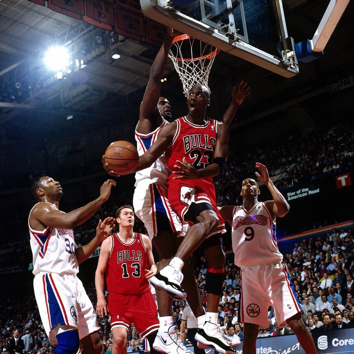 Michael Jordan of Chicago Bulls dunks against Philadelphia 76ers