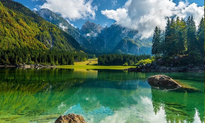 Serene Mountain Lake with Green Forest and Clear Sky