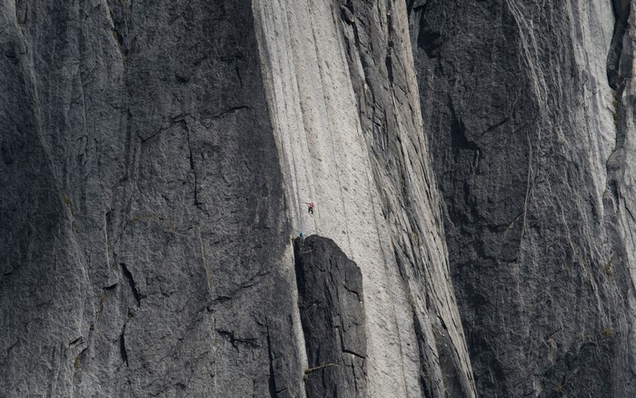 Rock climbers on a sheer cliff face
