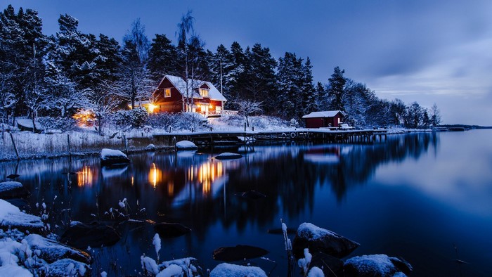 Cozy Cabin by Snowy Lakeside at Night