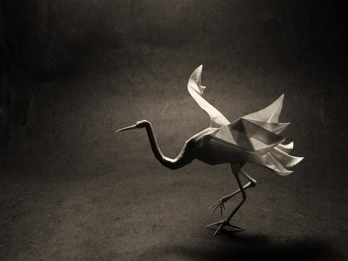 Origami crane bird in flight