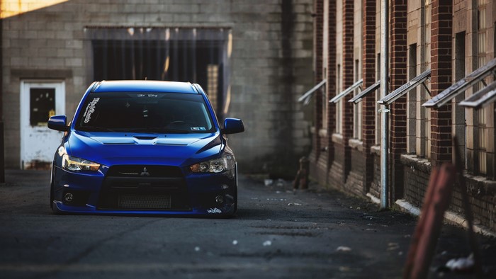 Blue Mitsubishi Lancer Evo X parked in alley