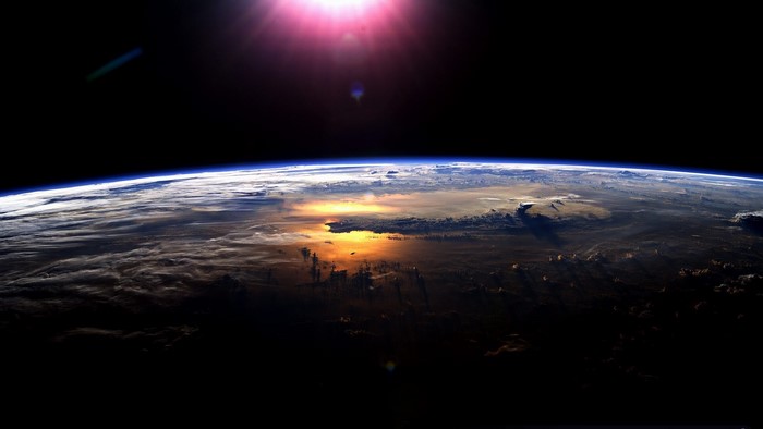 Earth from space with sun glare