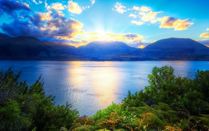 Sunset Over Mountain with Clouds and Vibrant Sky