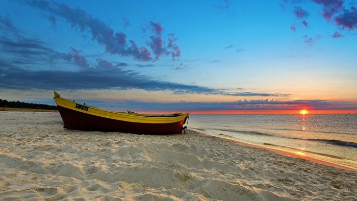 Boat on a beach at sunset