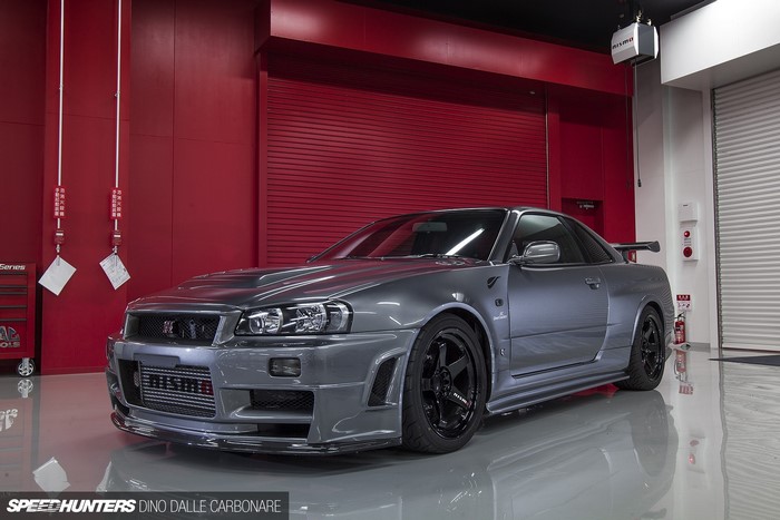 Silver Nissan Skyline GT-R R34 in Modern Garage
