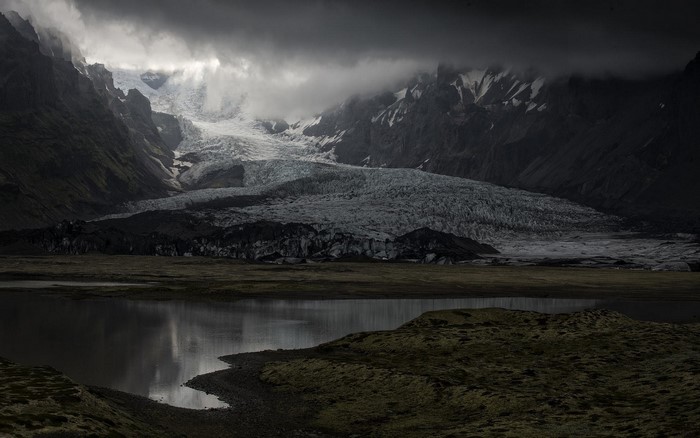Glacier and lake in Iceland under cloudy skies