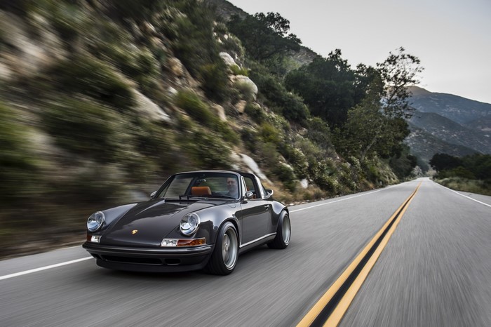 Dark grey Porsche 911 Carrera S Targa driving on a mountain road