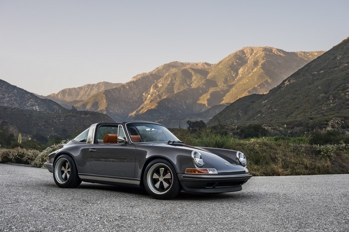 Porsche 911 Targa parked on a road with mountains