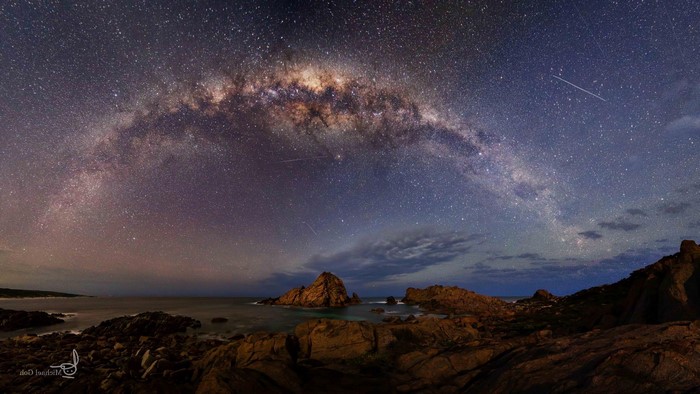 Milky Way over rocky coastline at night