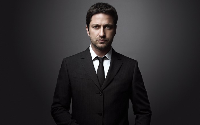Gerard Butler wearing a black suit and tie