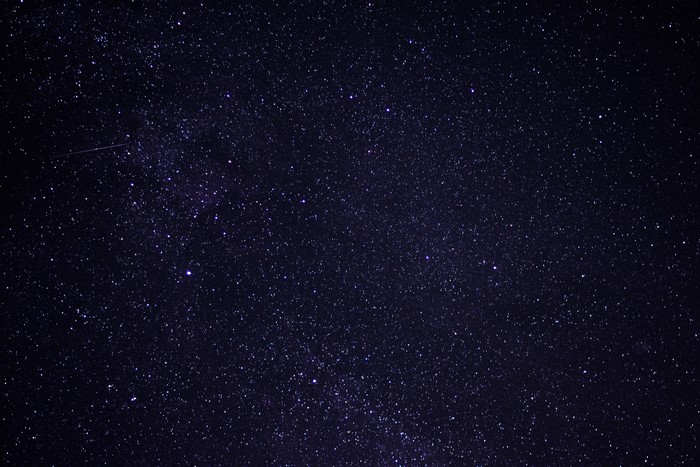 Night sky full of stars and a meteor