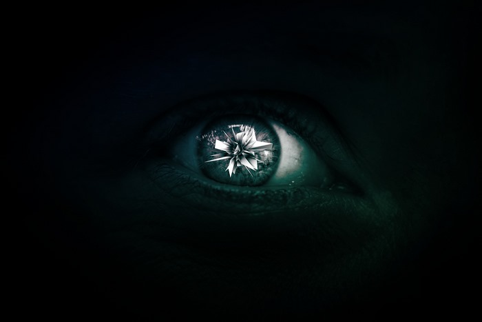 Close-up of an eye with a 3D abstract reflection