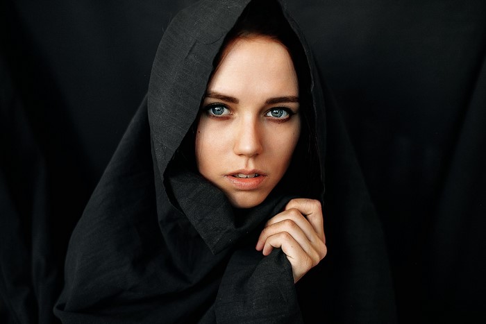 Woman in black headscarf looking at viewer
