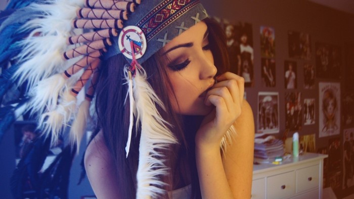 Girl wearing a Native American headdress