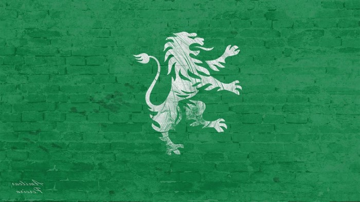 Sporting CP lion logo on green brick wall