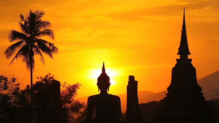 Sunset Silhouette of Buddha and Temple in Thailand