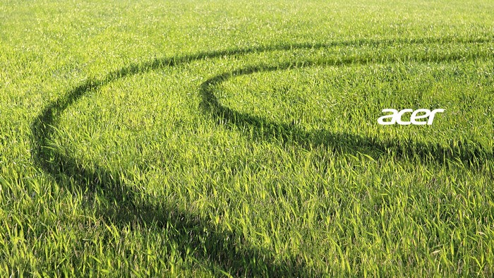 Acer logo on a grassy field with tire tracks