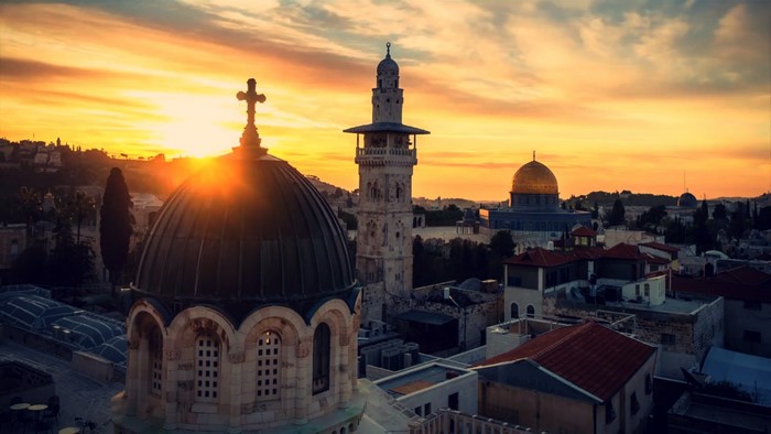 Jerusalem skyline at sunset with Dome of the Rock and church
