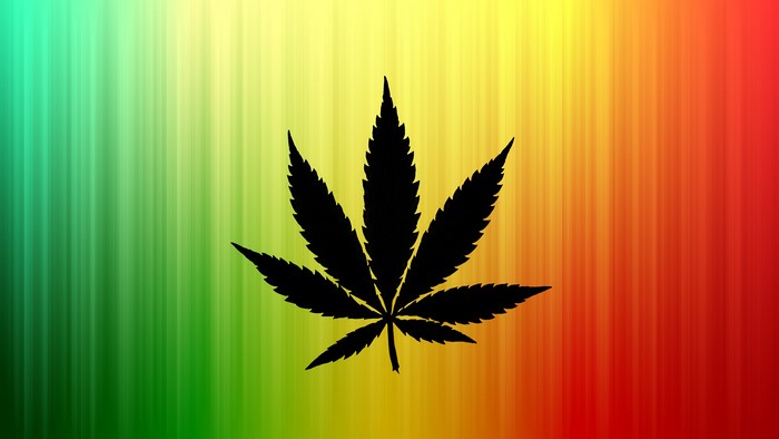 Cannabis leaf on Rastafari flag background