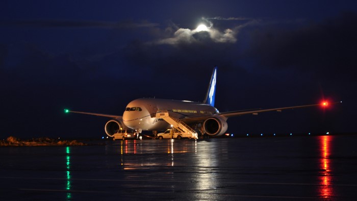 Airplane at night with moon and lights