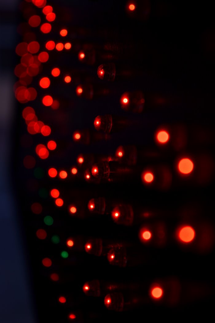 Blurred red and green LED lights on a dark background