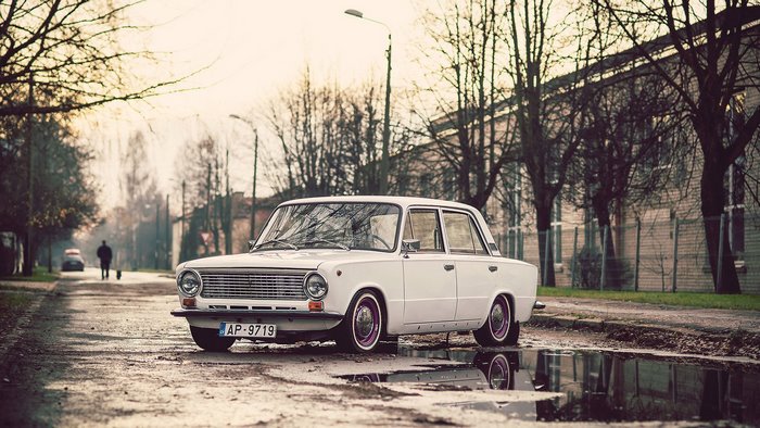 White Lada car on a wet street in Riga, Latvia