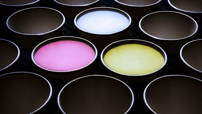 Bowls with colorful liquids and empty bowls