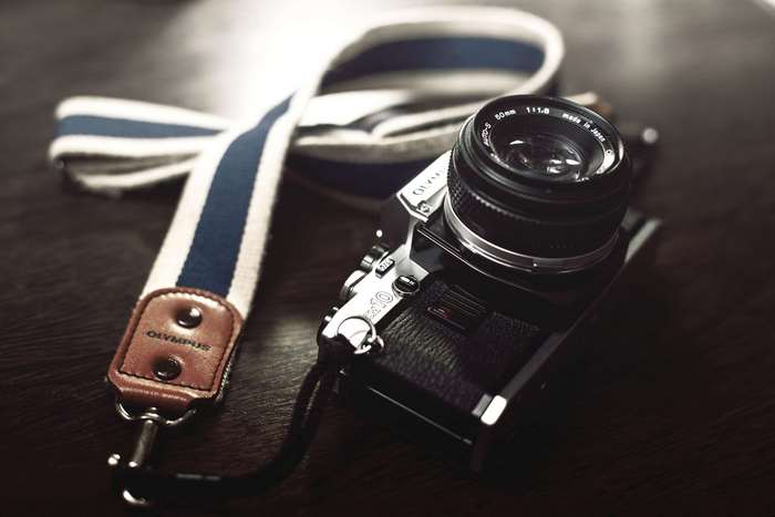 Olympus OM-10 analog camera with striped strap