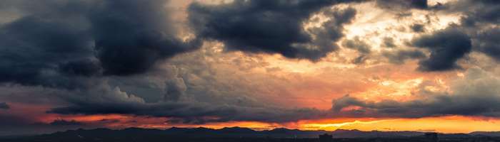 Dark storm clouds over mountains at sunset 4K