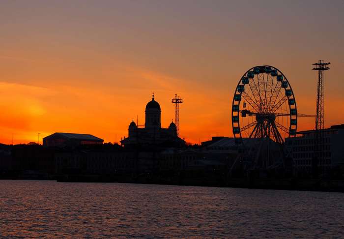 Helsinki skyline with Ferris wheel and cathedral at sunset